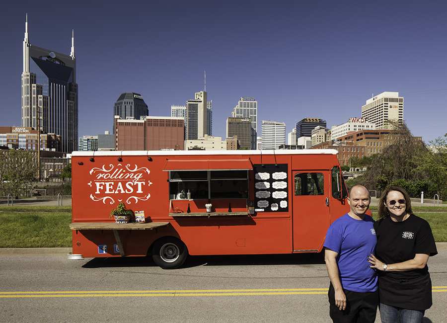 Tom and Cheryl standing in front of their food truck