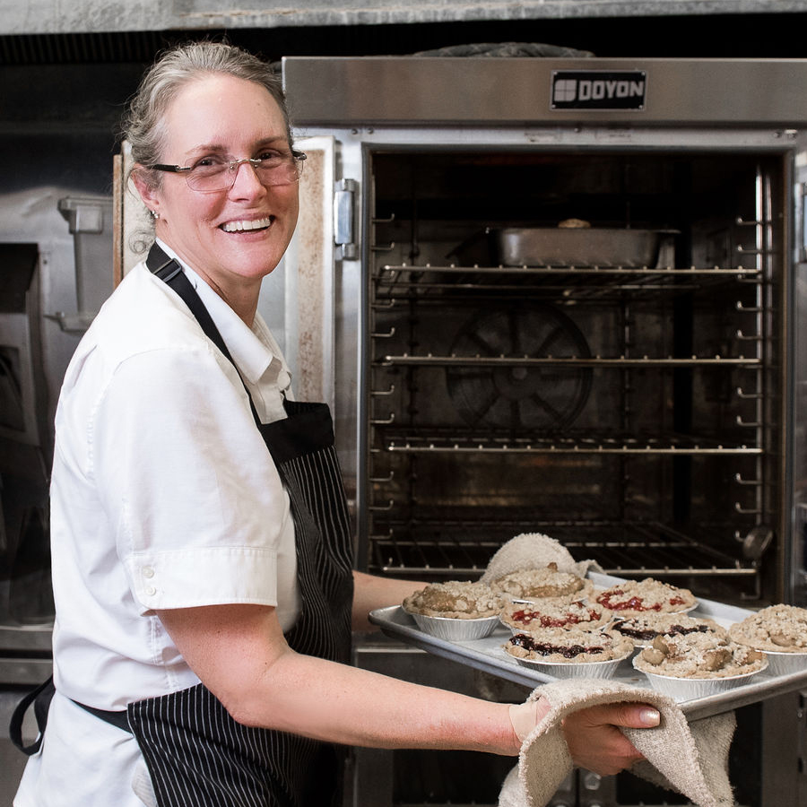 Cheryl Mead taking pies out of the oven